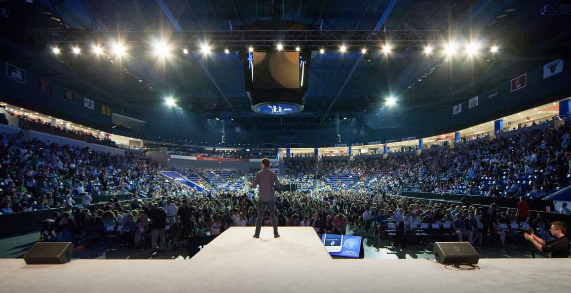 Speaker delivering keynote to large audience